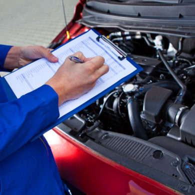 Mechanic reviewing a vehicle service checklist